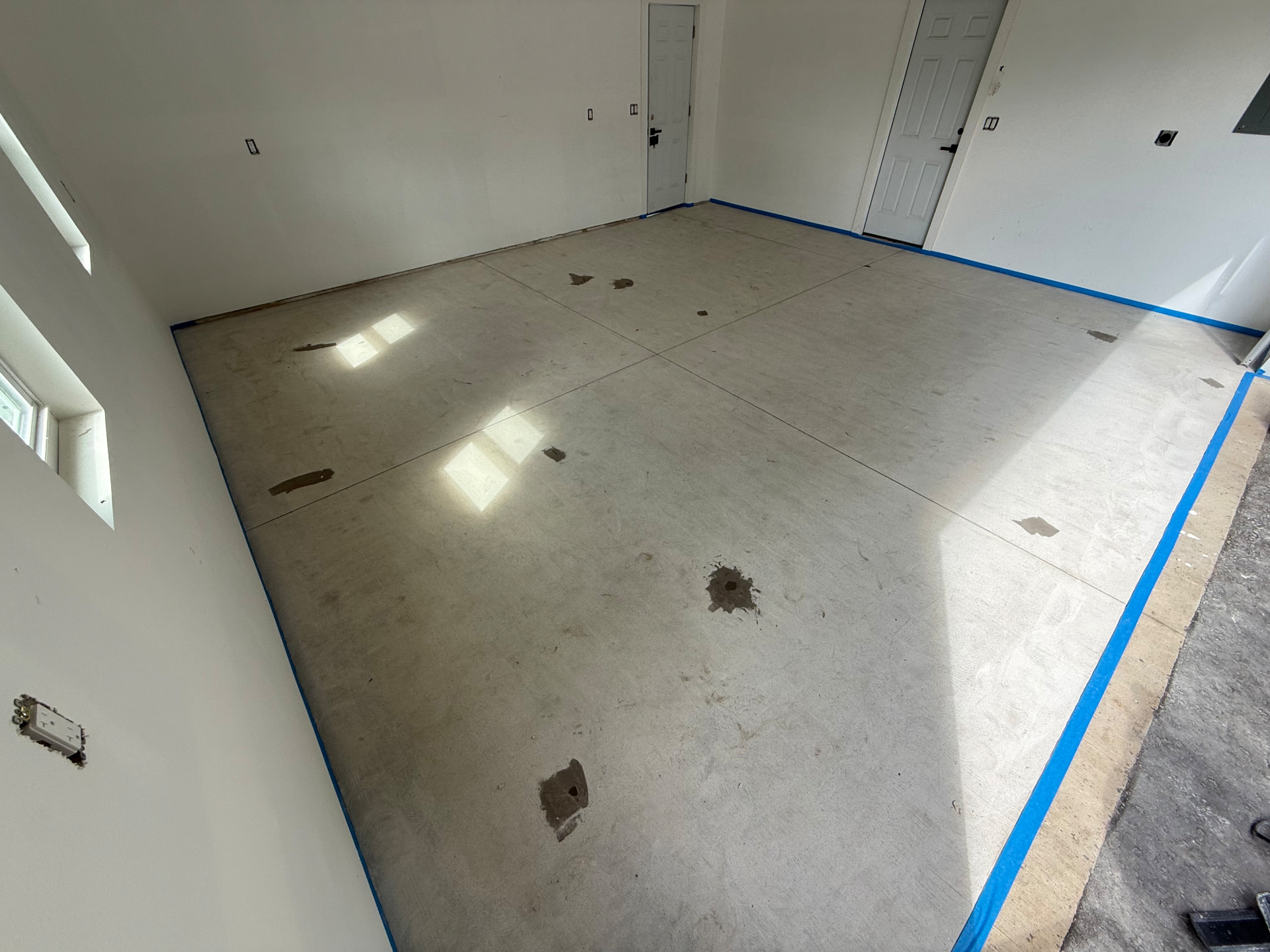 Worn concrete garage bay before epoxy coating in Southwick, MA
