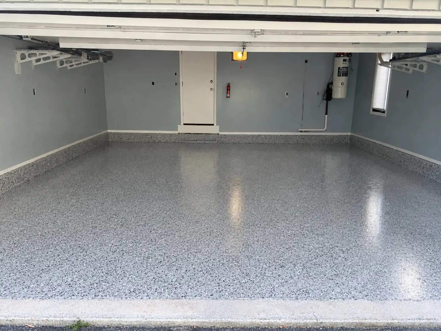 Completed Showroom package gray flake garage floor with coated stem walls in West Springfield, MA