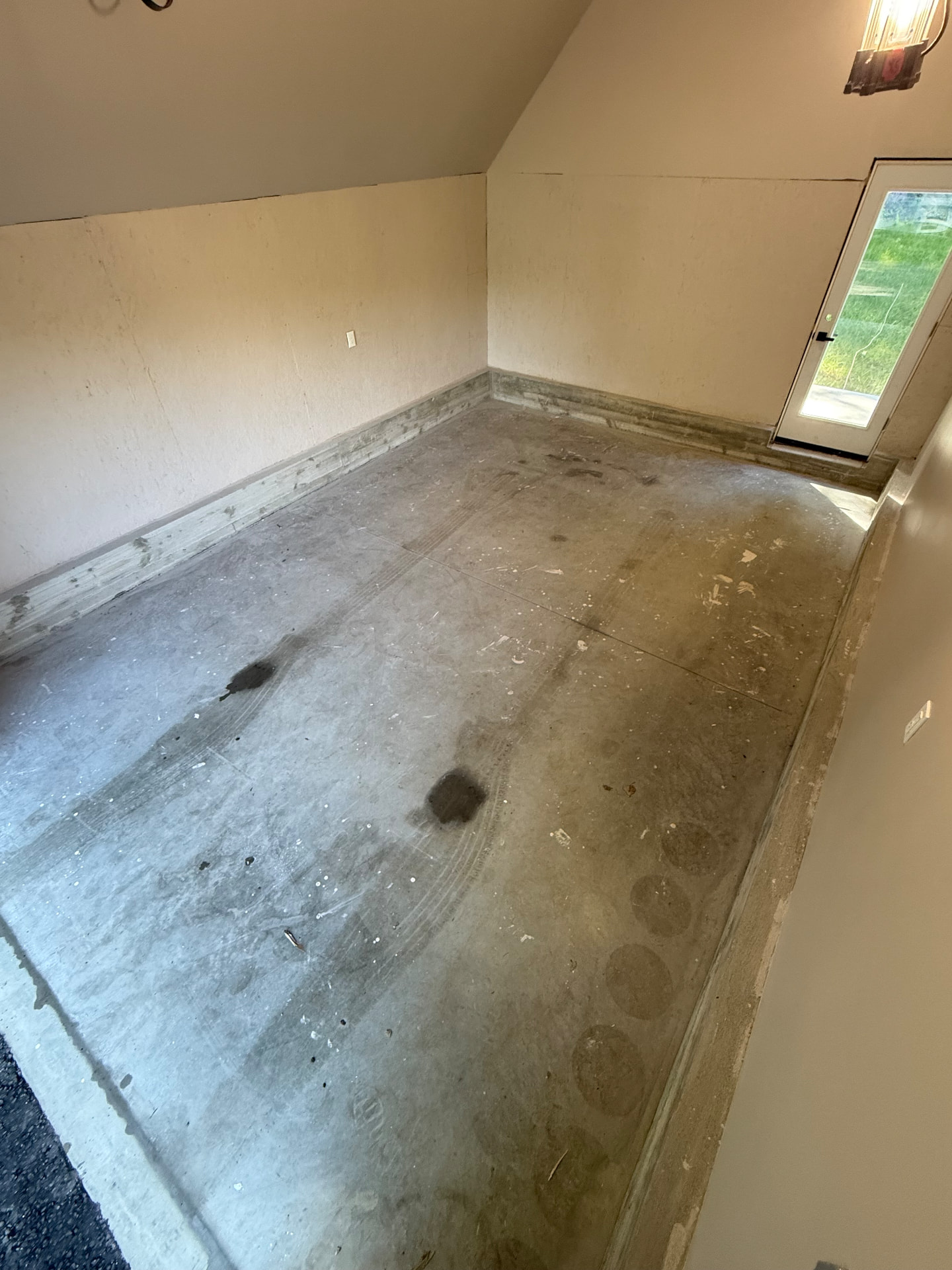Stained and worn concrete garage floor before coating in Westfield, MA